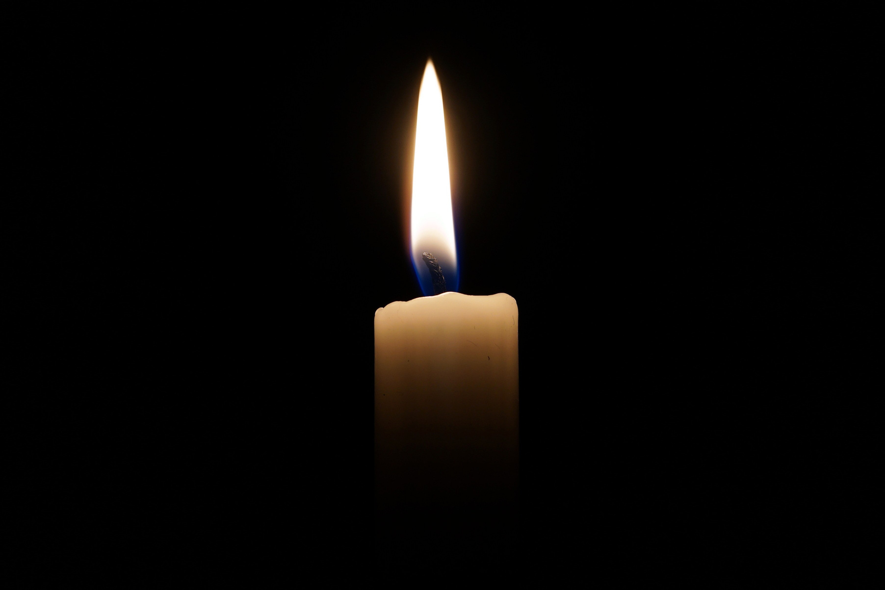 Lit Candle on a Black Background